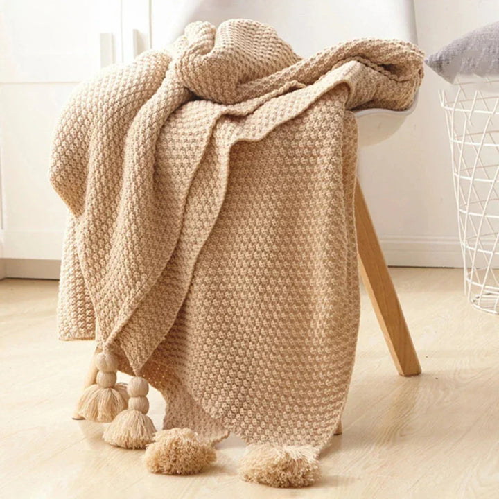 Cozy living room setup featuring a stylish knitted blanket