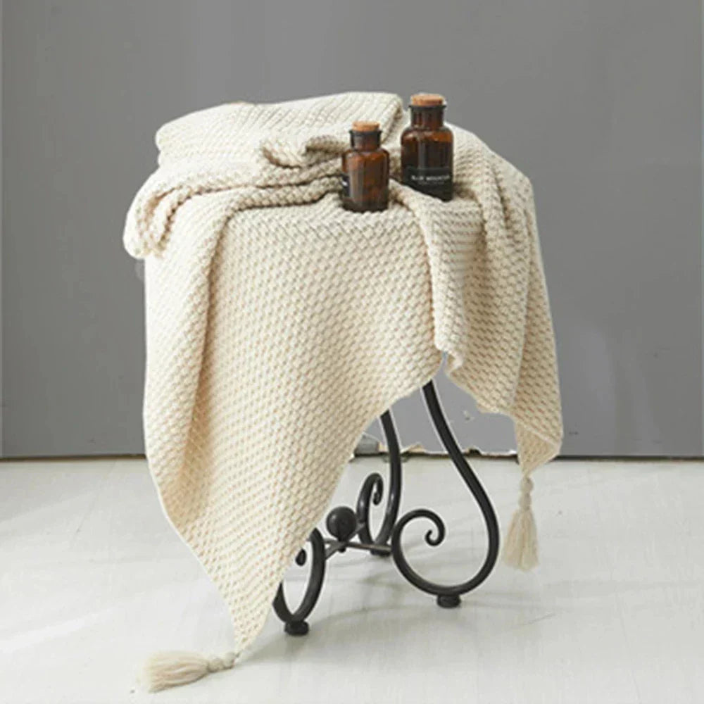 Hygge style knitted throw blanket draped across an armchair
