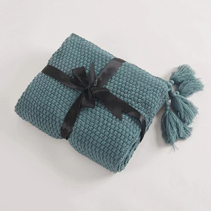 Warm blanket with textured knit pattern in a minimalist interior