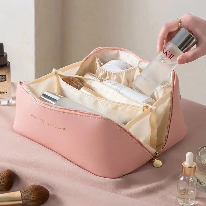 Interior mesh pockets of a travel makeup bag filled with cosmetics