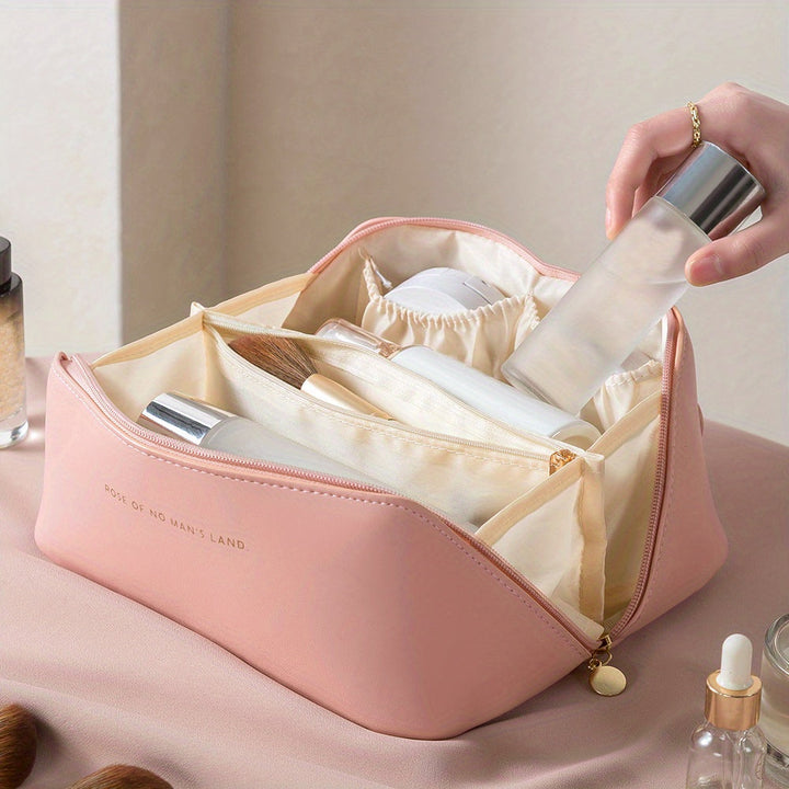 Pink travel makeup bag featuring sturdy gold zipper hardware detail