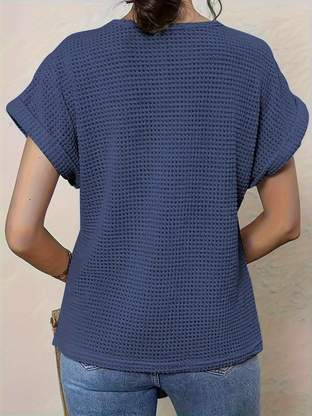 Styled womens top featuring geometric crochet pattern and short sleeves