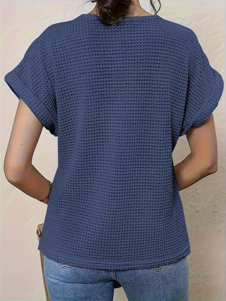 Styled womens top featuring geometric crochet pattern and short sleeves