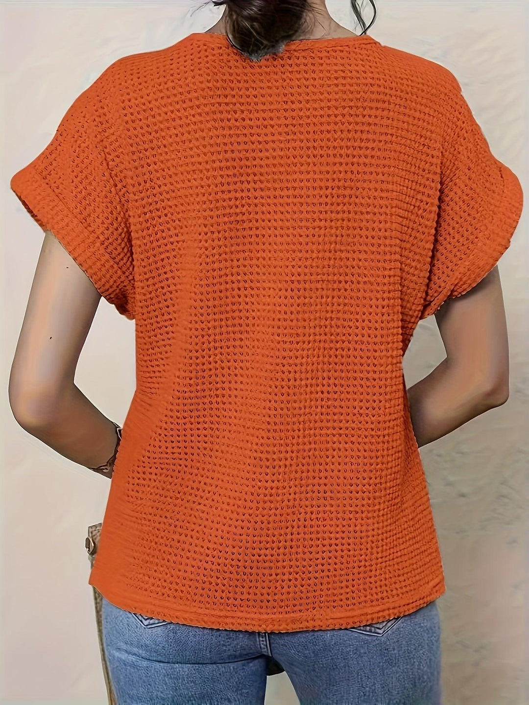 Detail of crochet top sleeve and hemline on womens casual wear shirt