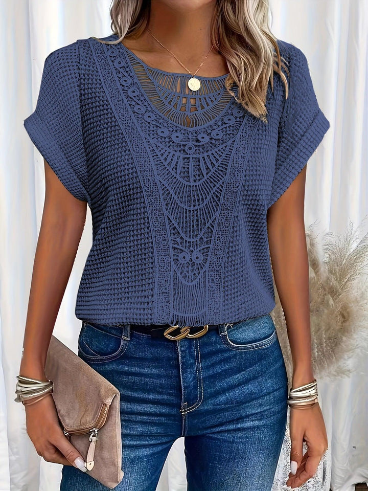 Woman wearing a navy blue lace short sleeve casual top