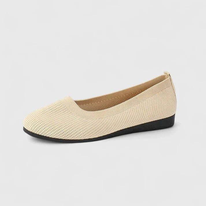 Beige knitted orthopedic slip-on flat shoe viewed from side