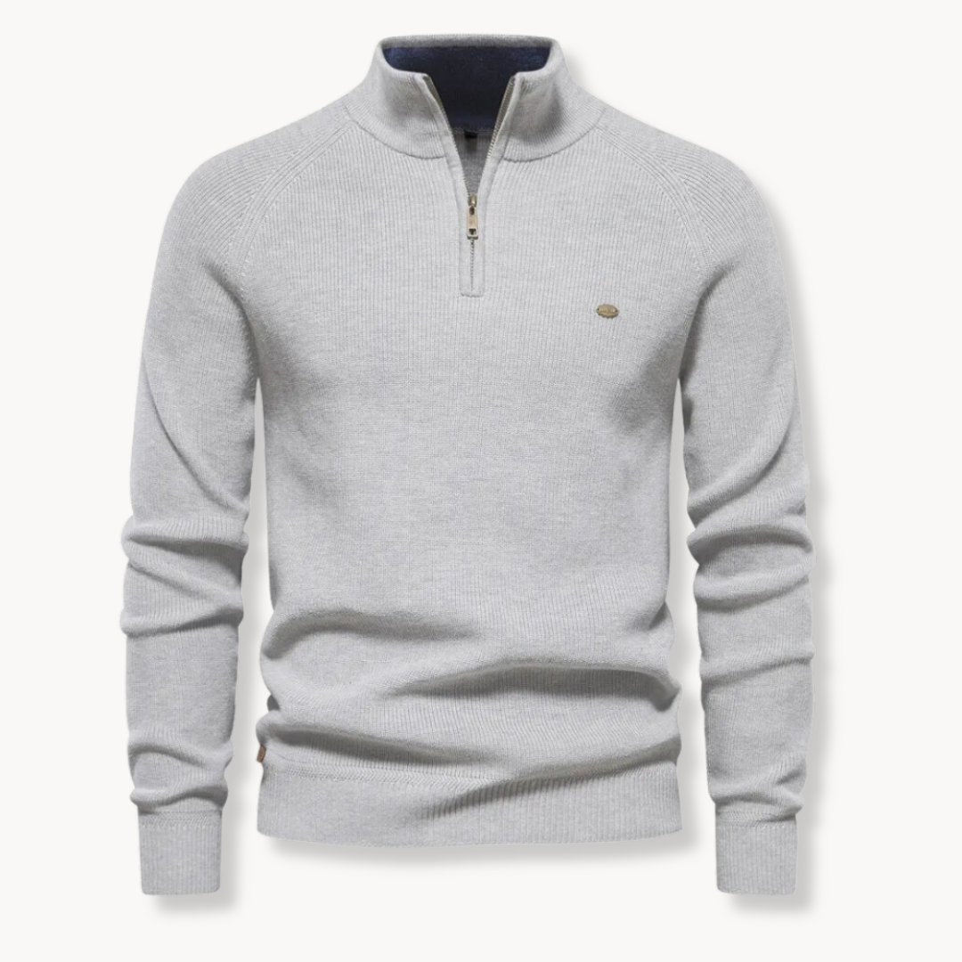 Close up of mens textured knitwear layering piece with quarter zip closure.