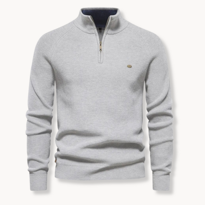 Close up of mens textured knitwear layering piece with quarter zip closure.