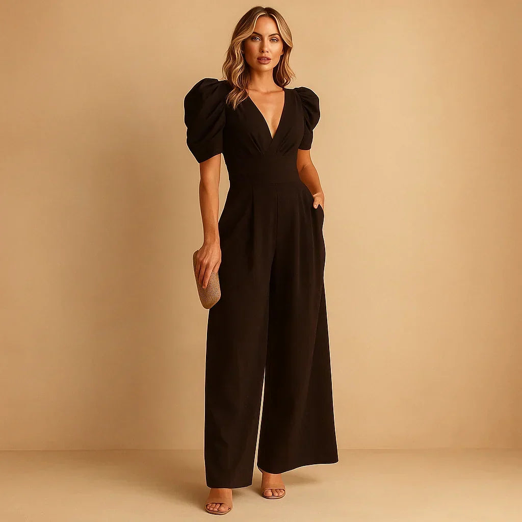 Woman wearing a black evening puff-sleeve jumpsuit with a V-neckline