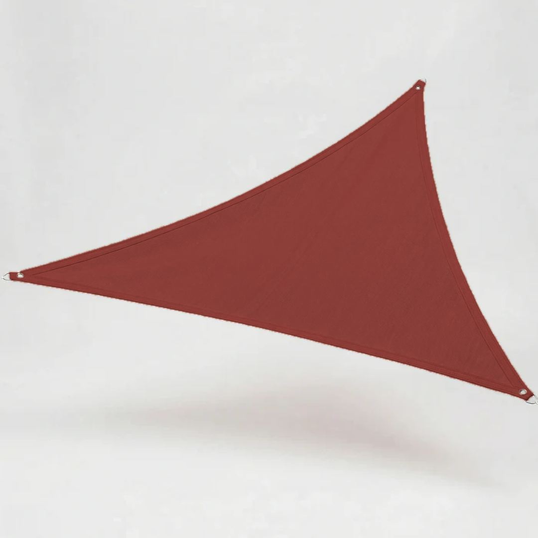 Large triangular sun sail shade canopy installed over a modern patio seating area