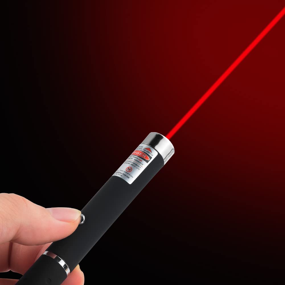 Close-up of a hand holding a black laser pointer projecting a bright red beam