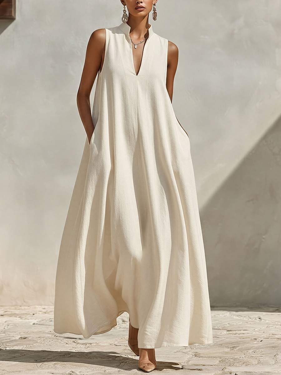 Model wearing a cream sleeveless V-neck maxi dress with side pockets