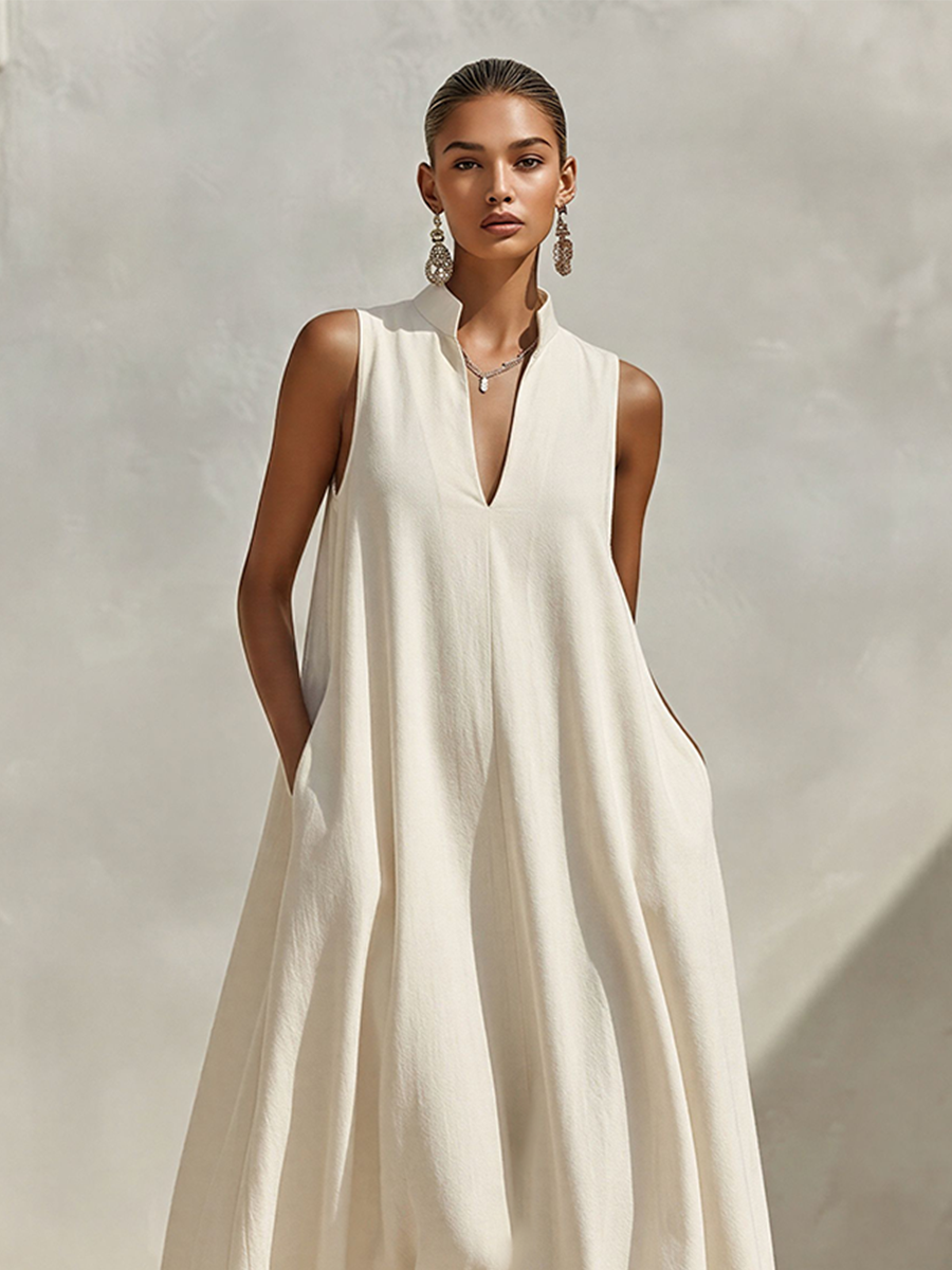 Close-up view of the stand collar and V-neckline on the cream dress