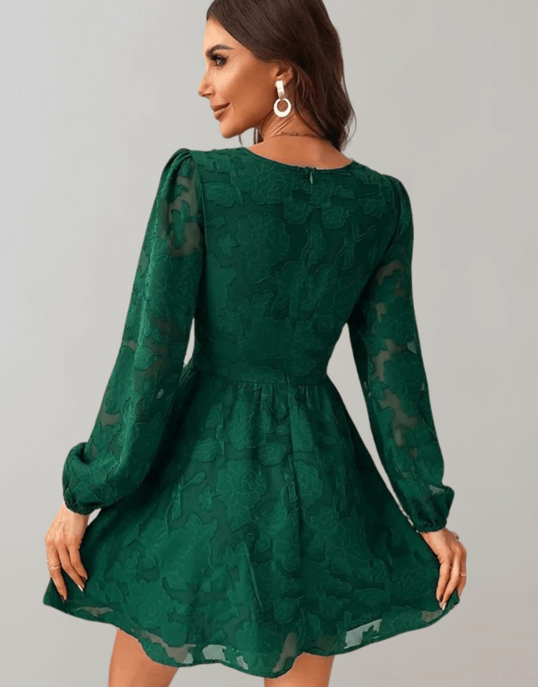 Back view of the green long sleeve party dress showing A-line silhouette