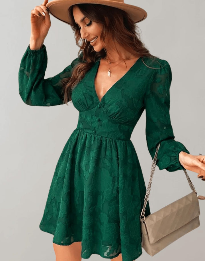 Model accessorizing the green floral party dress with a hat and handbag