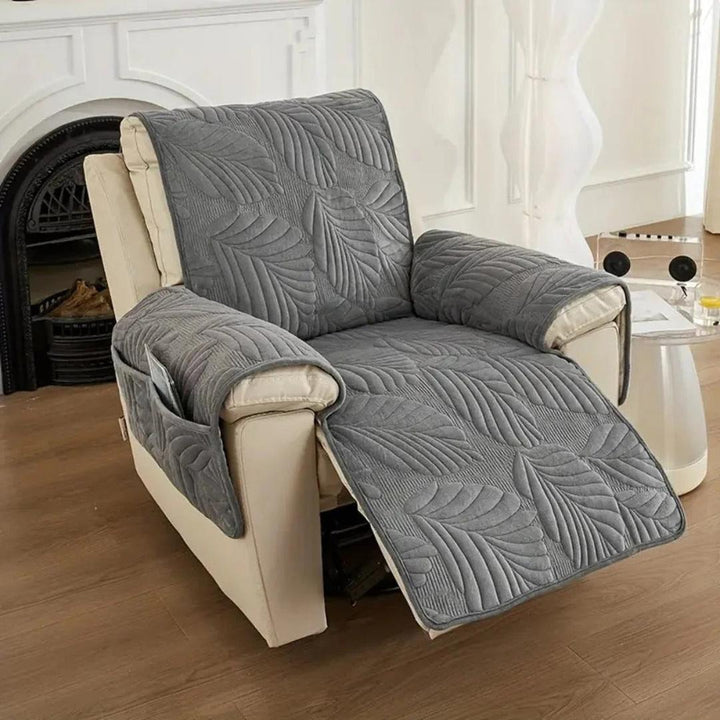 Dark gray leaf pattern quilted recliner cover on an armchair