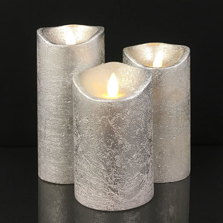 Rustic red and gray LED pillar candles set glowing in a warm living room setup