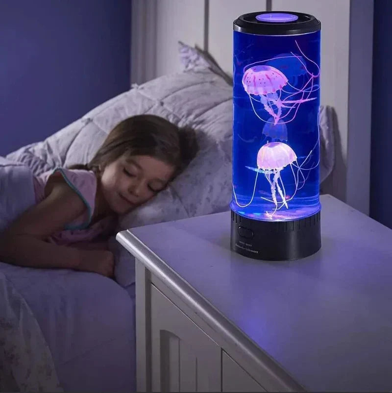 Child sleeping next to a glowing LED jellyfish lava lamp on a nightstand