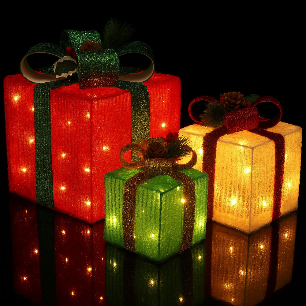 Set of three vibrant LED lighted gift boxes in red, green, and yellow with festive bows.