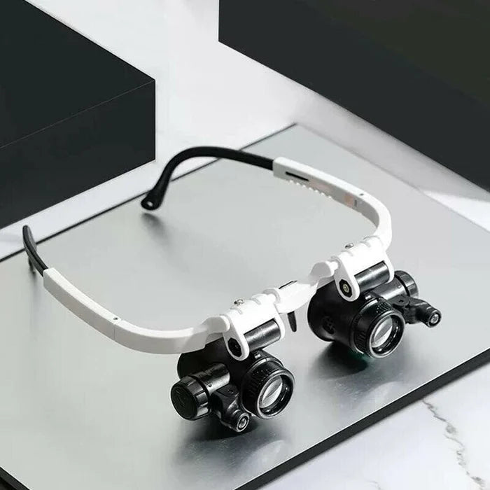 Black LED magnifying glasses resting on a metallic surface