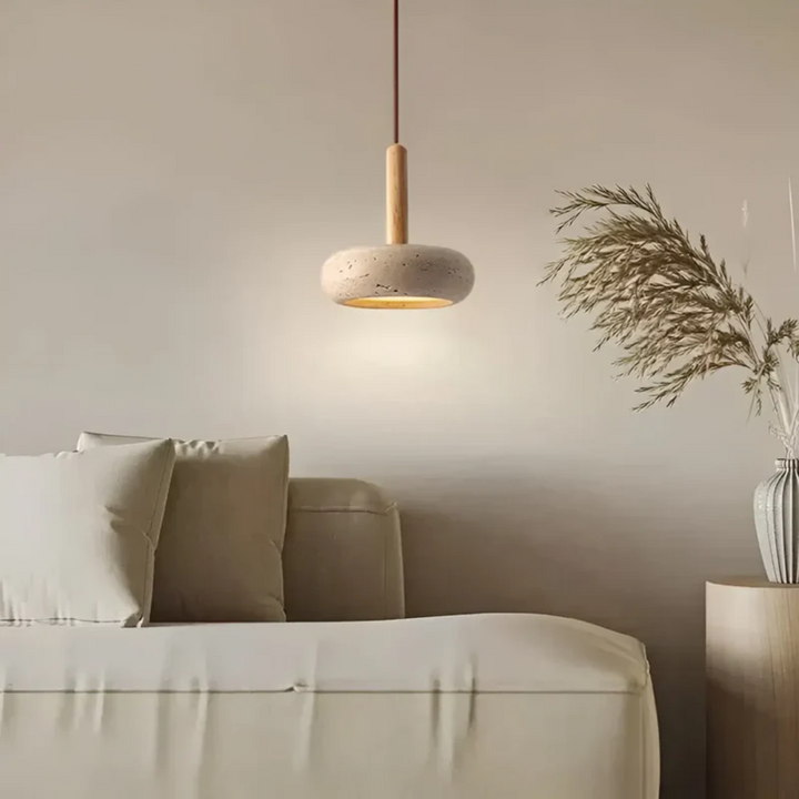 Interior design view of the minimalist wooden hanging light installed over a wooden table