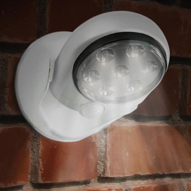 White LED sensor lamp mounted on an exterior brick wall
