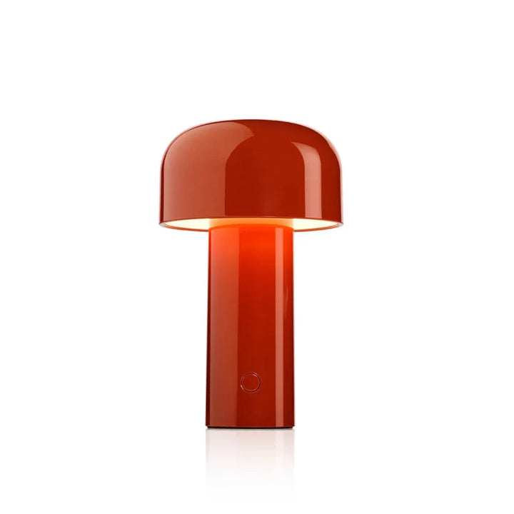 Studio product shot of the red rechargeable LED mushroom table lamp lit up with ambient light.