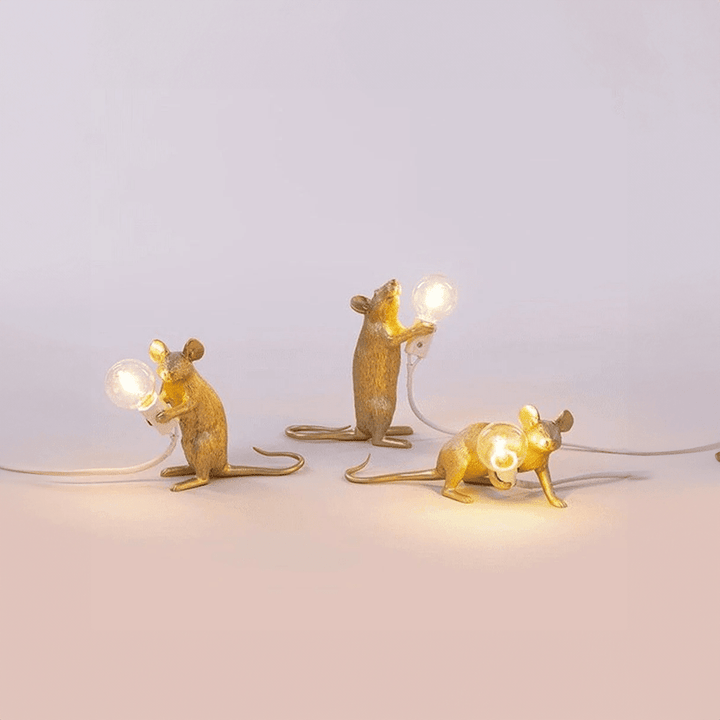 Gold resin LED mouse table lamps displayed in horizontal, sitting, and standing postures