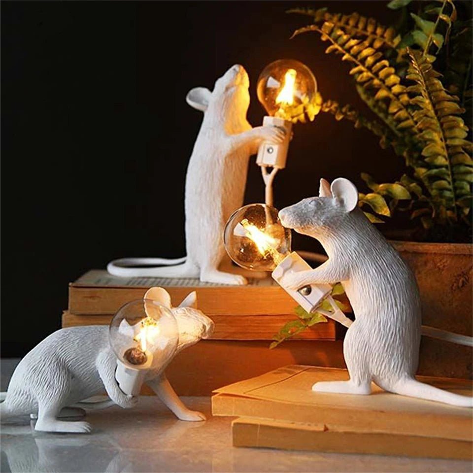 White LED mouse table lamp illuminating a cozy bedside table setup next to books and plants