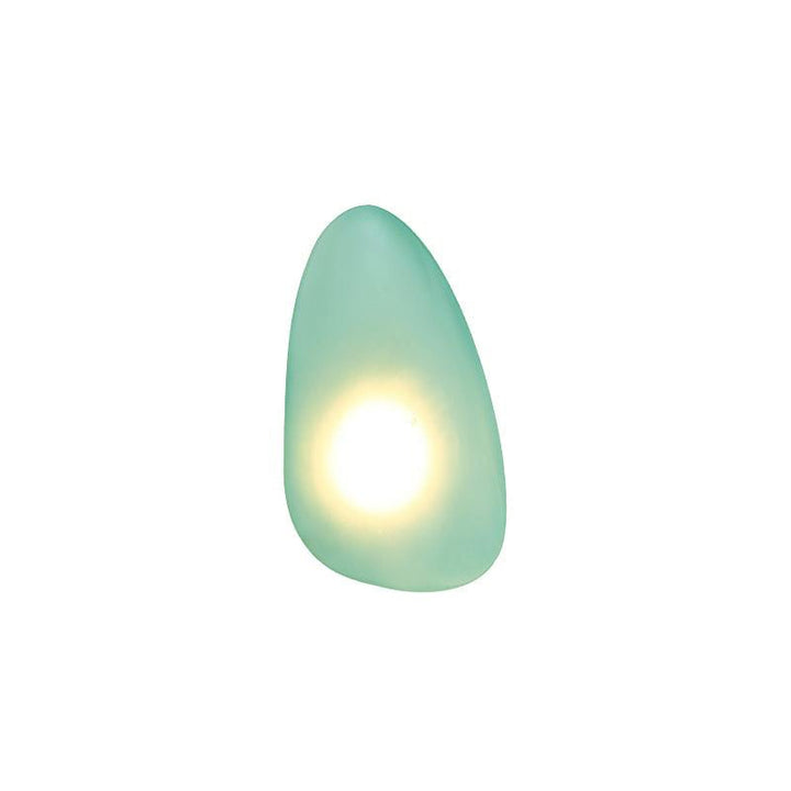 Designer glass wall sconce creating elegant shadow patterns