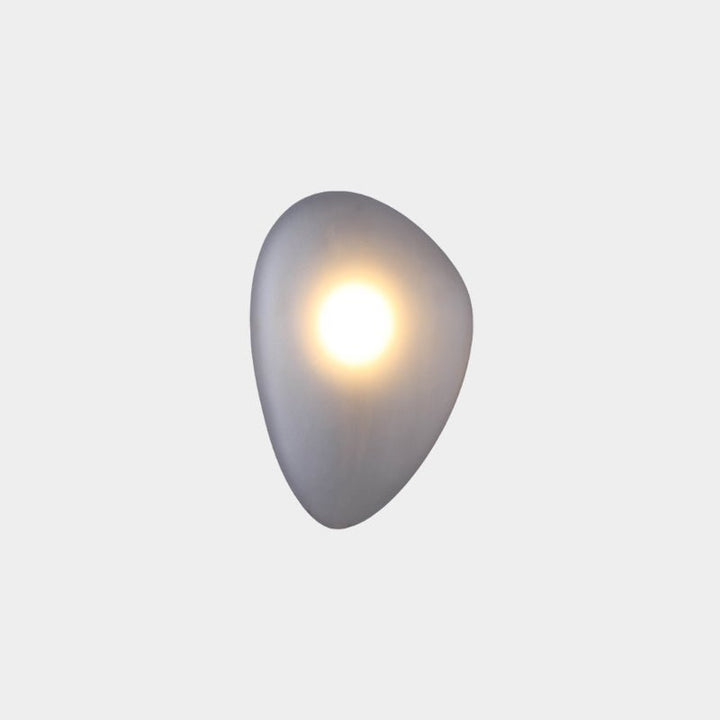 Close-up of glass wall sconce texture and modern LED hardware
