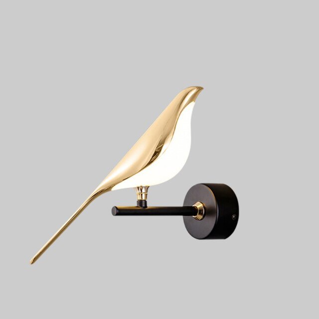 Single golden bird LED wall lamp mounted on a grey wall