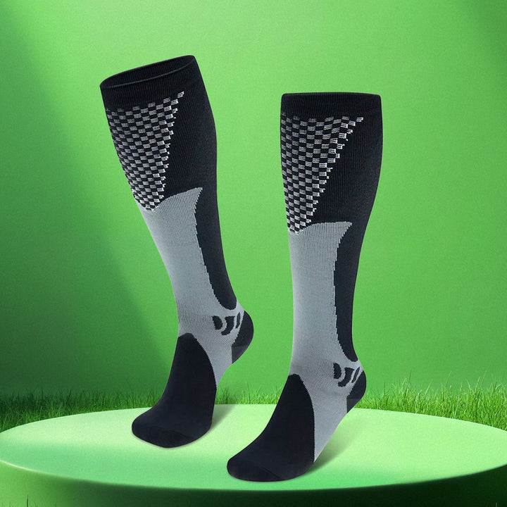 Unisex travel socks laid flat to show full length and graduated compression zones.