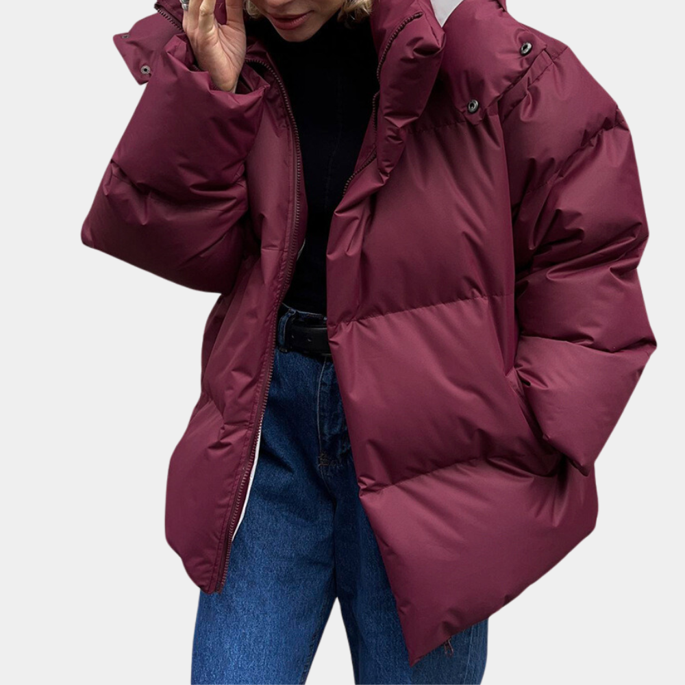 Woman wearing a wine red lightweight quilted winter puffer coat with hood