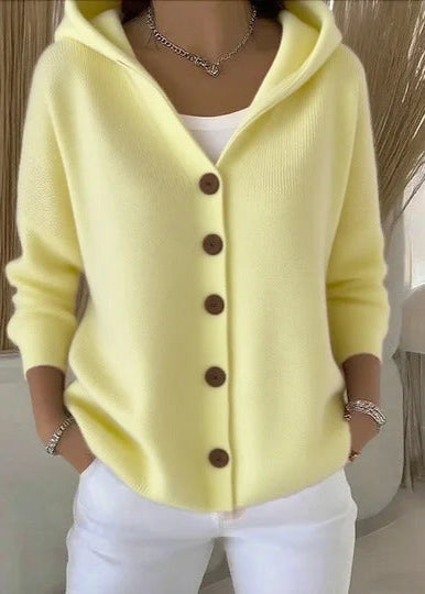 Flat lay of women's button-up cardigan sweater with hood
