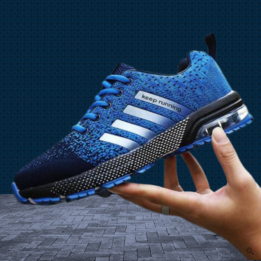 Blue orthopaedic walking sneaker held in hand showing air cushion sole