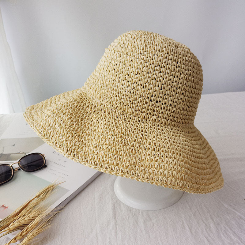 Women's beige retro flat summer sun hat displayed on a stand