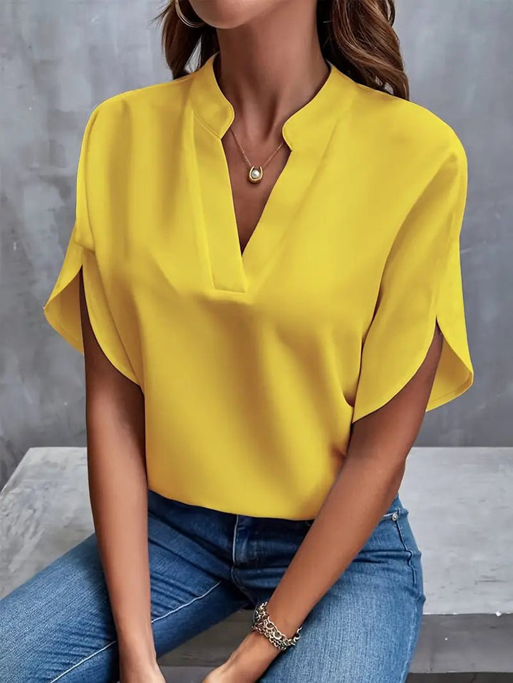 Detailed shot of hemline and fabric texture on V-neck shirt