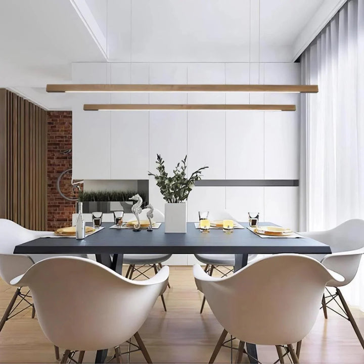 Modern LED linear wood pendant light illuminating a kitchen island