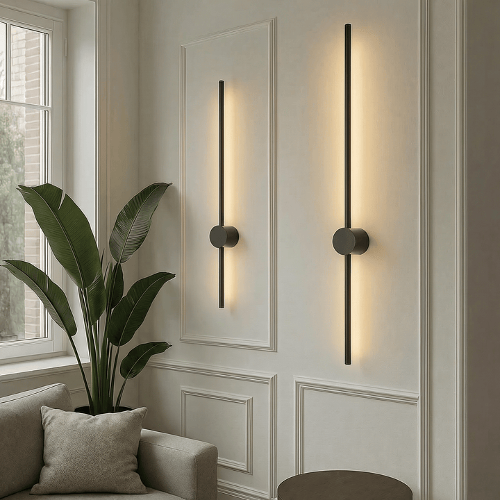Modern black LED linear wall lamp mounted beside a potted plant in a living room