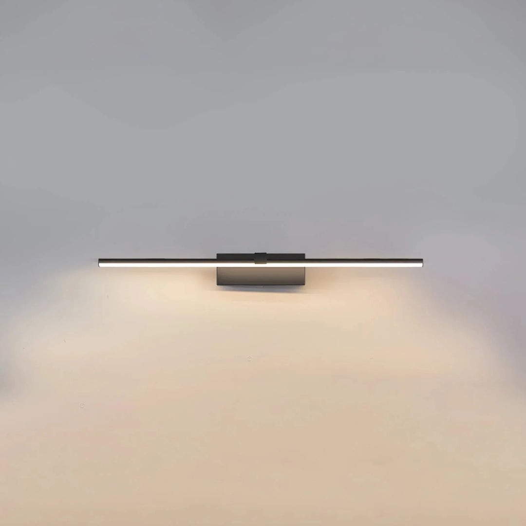 Black linear LED wall light glowing against a plain wall