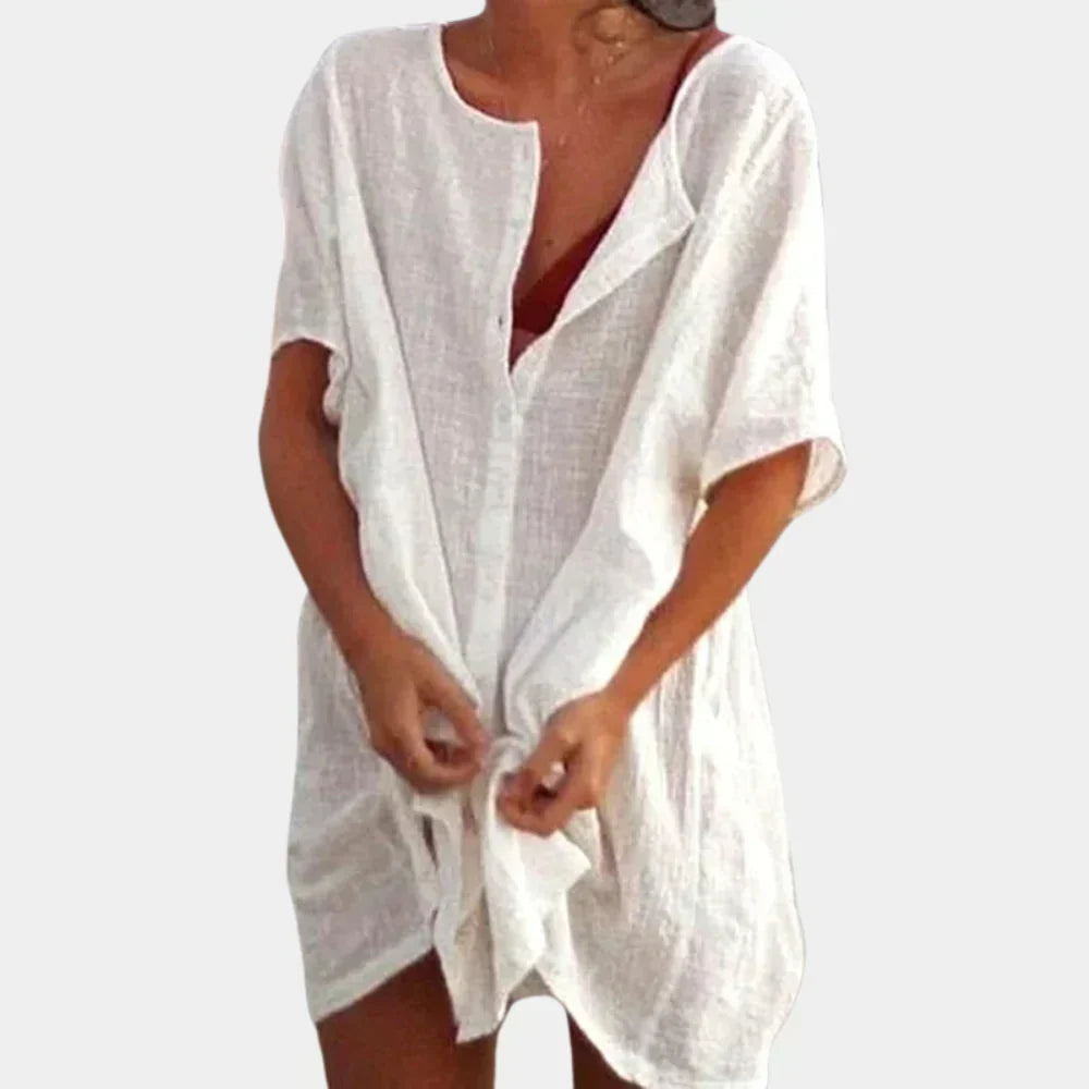 Woman wearing a white casual beach tunic over swimwear