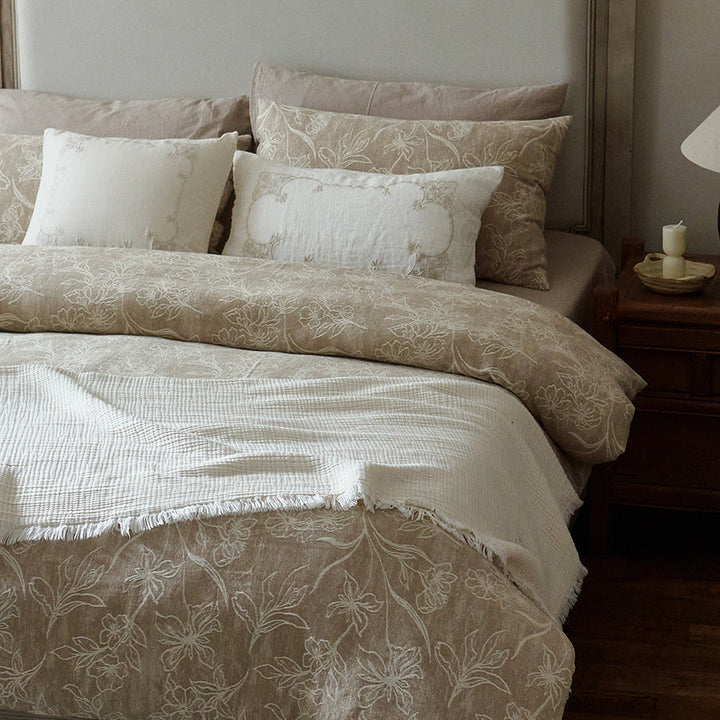 Detailed view of the textured floral pattern and coordinating pillowcases