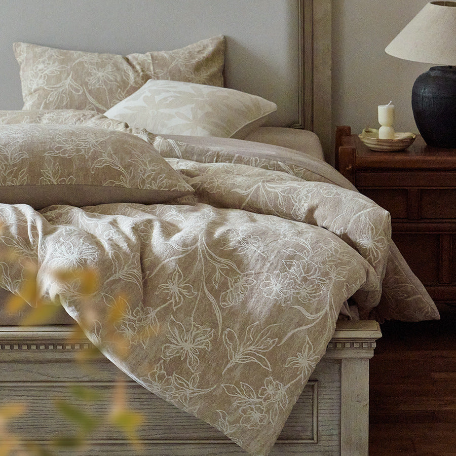 Floral jacquard bedspread texture close-up showing intricate woven pattern