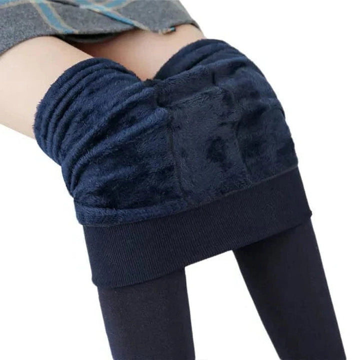 Flat lay of women's thermal leggings highlighting elastic high waist design