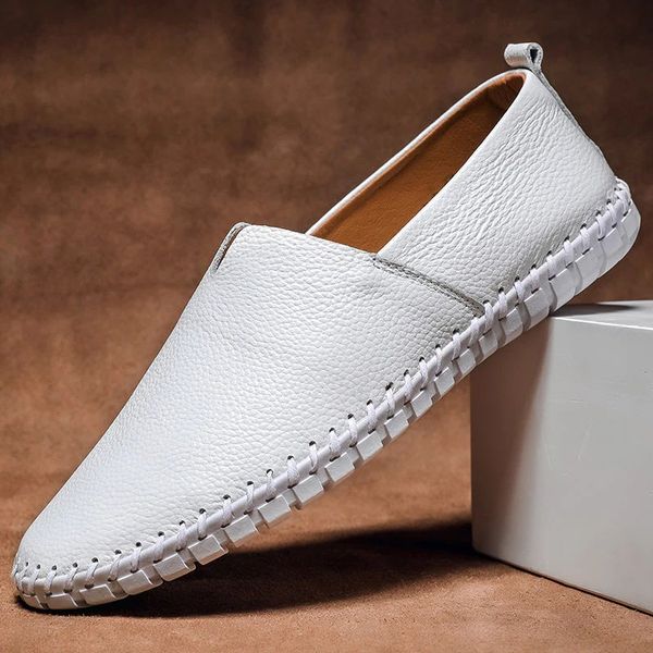 White men's minimalist slip-on shoes displayed on white block