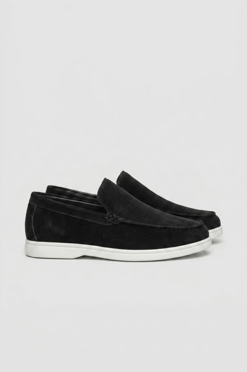 Black men's slip-on loafers with white sole viewed from the side