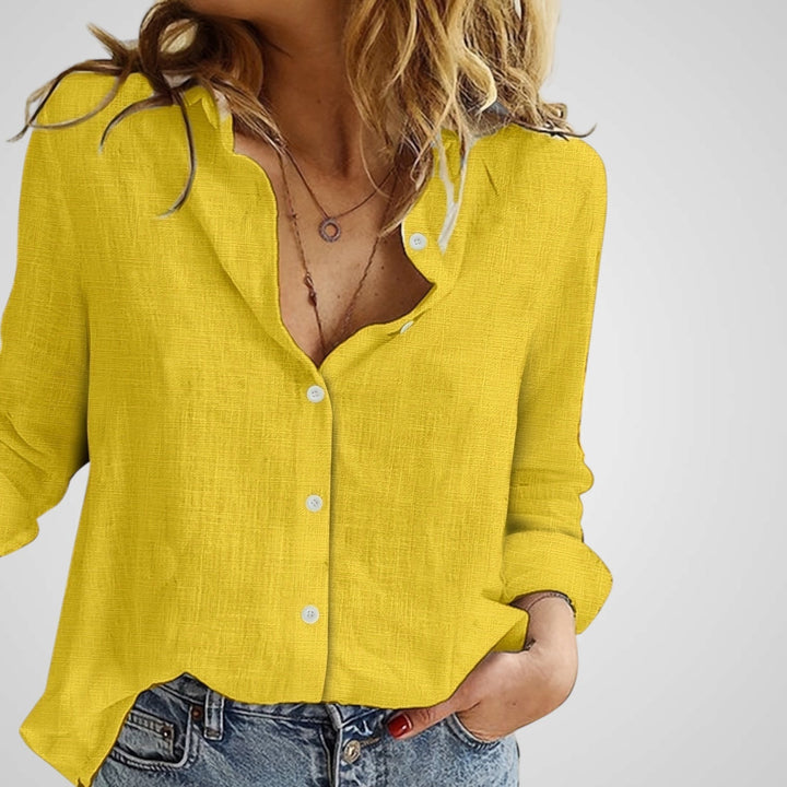 Close-up of textured top material and classic button closure on women's blouse