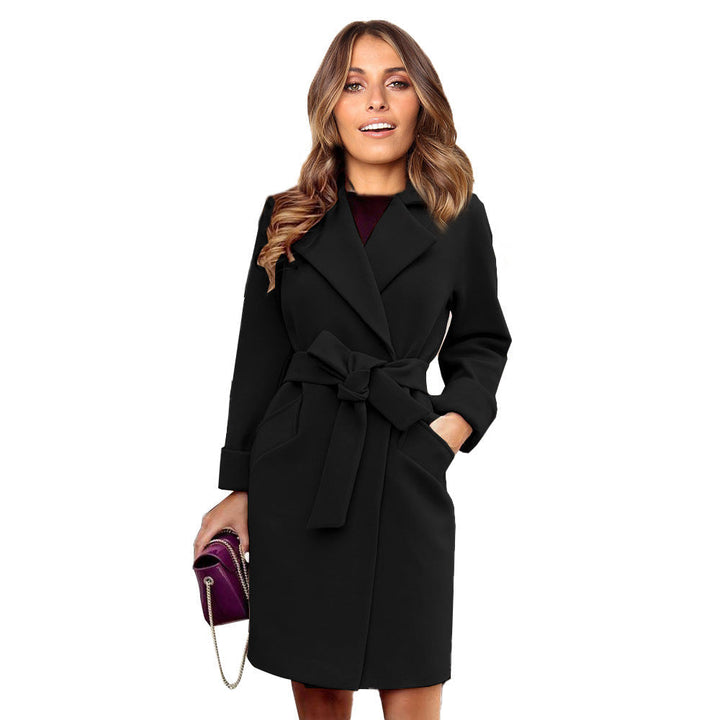 Woman wearing black double-breasted winter coat with belt