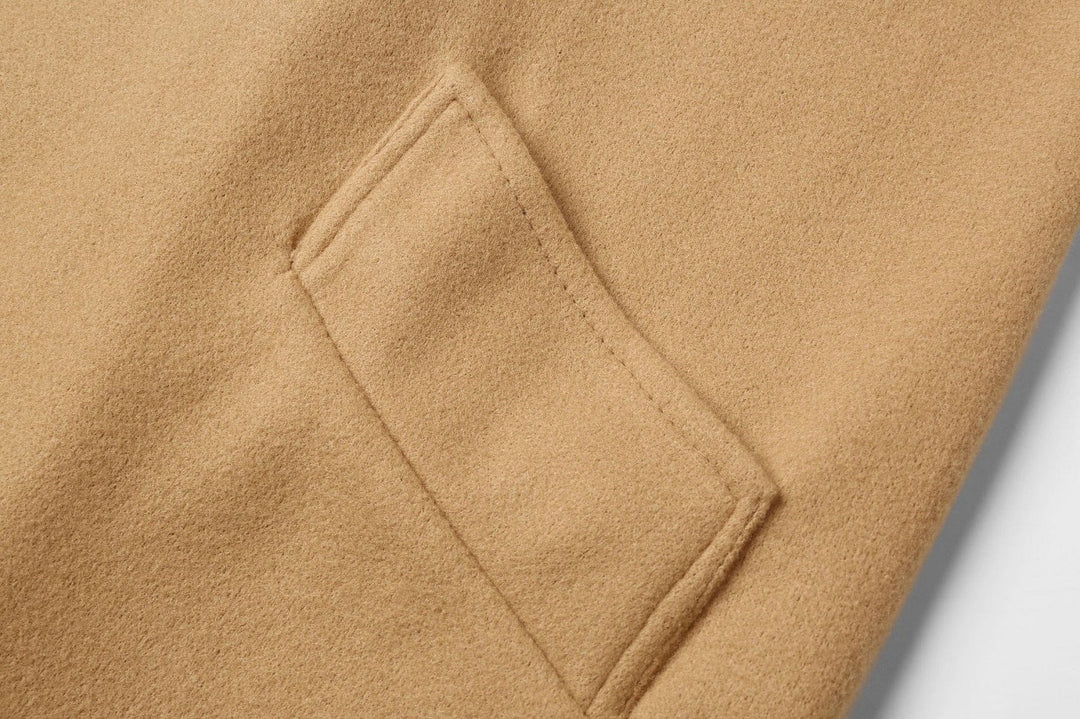 Women's double-breasted long winter coat back view showing tailored fit and vent